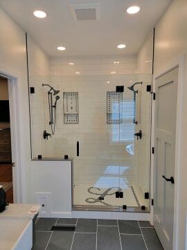 Uniquely shaped custom glass shower enclosure, installed by Great Lakes Glass in Cleveland, Ohio