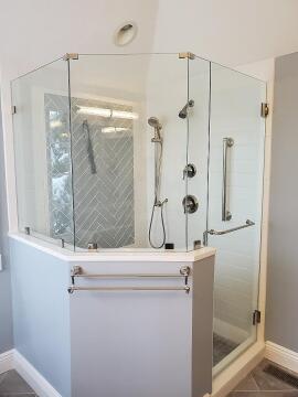 Frameless glass shower enclosure over half wall installed by Great Lakes Glass in Cleveland, Ohio
