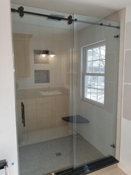 Frameless barn door style sliding glass shower doors installed by Great Lakes Glass in Cleveland, Ohio