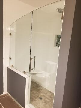 Custom curved top glass shower door and panel cut and installed by Great Lakes Glass in Cleveland, Ohio