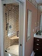A custom frameless glass shower door made by Great Lakes Glass