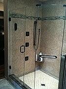 A wraparound frameless glass shower installed by Great Lakes Glass
