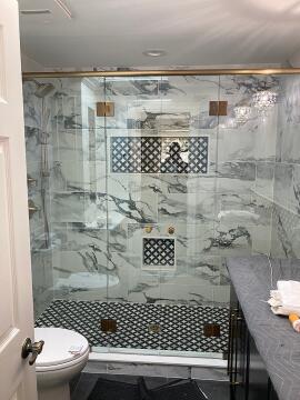 Gold framed custom swing glass shower doors installed by Great Lakes Glass in Cleveland, Ohio
