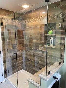Corner glass shower enclosure with swing style custom glass shower door, installed by Great Lakes Glass in Cleveland, Ohio