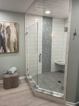 Glass shower enclosure with swing style custom glass shower door, installed by Great Lakes Glass in Cleveland, Ohio